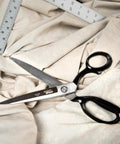 10 Inch Bent Handle Industrial Shears on fabric, used for heavy duty cutting of upholstery, carpet, and drapery materials.