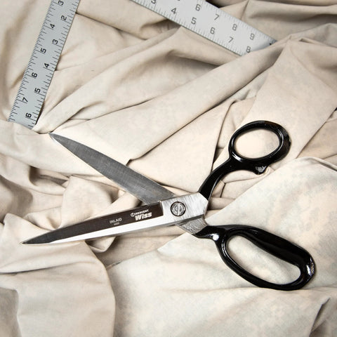 10 Inch Bent Handle Industrial Shears on fabric, used for heavy duty cutting of upholstery, carpet, and drapery materials.