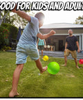 Children and adults playing with 10 Inch Kickball Playground Balls - (Pack of 6) Inflatable Rubber Indoor Outdoor Bouncy Balls on grass.