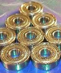 10-Pack Bearings 1603ZZ 5/16" x 7/8" x 9/32" - Miniature Bearings in triangular arrangement on metallic surface