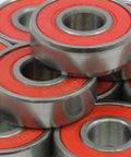 100-Pack 608-2RS Skate Ball Bearings - Red Seals stacked showing the durable steel and red seals.