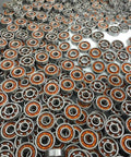 100-Pack Skate Ball Bearings - Nylon Cage - Open arranged in a uniform pattern showcasing their design and quality.
