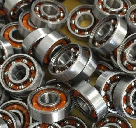 100-Pack Skate Ball Bearings - Nylon Cage - Open, close-up view of bearings showing steel outer casing and nylon retainer.