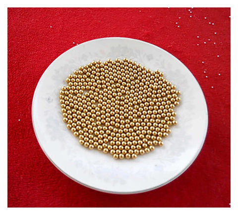 Plate of 100-Pack 3.175mm Ceramic Balls Solid H62 Brass Ball - Precision Smooth Beads Round Balls on red background