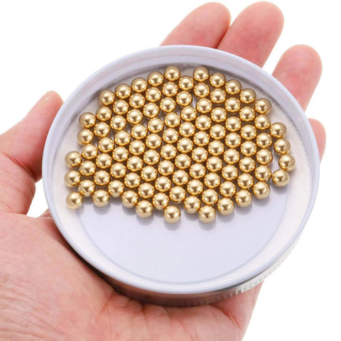 Hand holding 100pcs 6mm Solid Brass Bearing Balls - Industrial Brass Ball Spheres for Machinery, Automotive, and DIY projects.