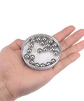 Hand holding a tin of 10mm Stainless Steel Bearing Balls G100 Precision 304 Grade Dope 20 Pack for Smooth Friction Corrosion Resistant