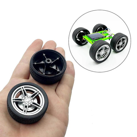 Hand holding wheels from 10PCS Toy Car Wheels 40mm Rubber Tire Wheels with Metal Shaft for RC Car Truck DIY Model Toy Wheel Replacement Accessories