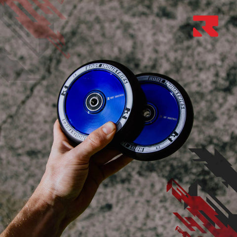 Hand holding two 110mm AIR Scooter Wheels Black Blu Ray Lightweight Durable Pro Scooter Wheels Built for Smooth Control Easy Installation