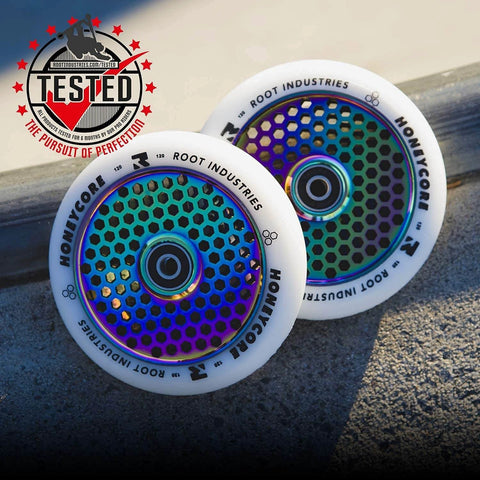 110mm Pro Scooter Wheels Pair White Rocket Fuel with Bearings Installed on concrete background, featuring hexagonal pattern and logo.