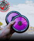 Hands holding 110mm AIR Scooter Wheels Black Purple Lightweight Durable Pro Scooter Wheels Designed for Smooth Control Easy Installation
