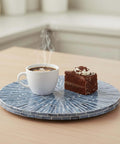 12.6 inch mother of pearl lazy susan turntable with blue starburst design featuring coffee cup and chocolate cake on countertop.