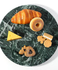 12 inch marble lazy susan turntable made from natural green marble, rotating serving tray with pastries and cheese.