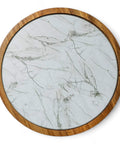 Close-up view of the removable glass plate of a 12 inch acacia wood lazy susan turntable with marble texture.
