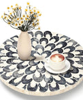 12 inch mother of pearl lazy susan turntable with floral pattern, decorative wooden tray holding a vase and coffee cup.