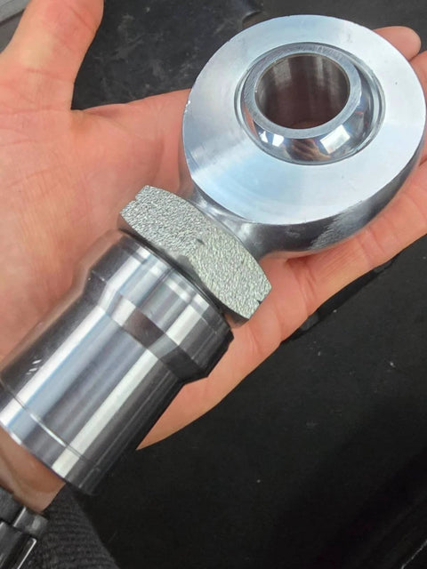1 1/4 Heim Joints Rod End Kit close-up held in hand, 1.25 Chromoly Joints with Round Tube Adapters and High Misalignment Spacers