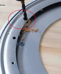 Installation of 12 Inch Lazy Susan Base Only For Glass Granite Or Wood Tables, showing drilling process on metal surface with drilled hole.