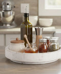 12 Inch Wood Lazy Susan Turntable Organizer on kitchen counter holding spices, oil, and condiments; rustic farmhouse decor style.