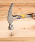 12 Oz Straight Rip Claw Hammer With Smooth Face And Genuine Leather Grip For Framing Carpentry Demolition And Woodworking Made In USA From Forged Steel Pro Grade Hand Tool For Precision Strikes And Durable Performance in use driving a nail into wood.