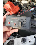Hand holding Automotive Relay Tester Kit 12V Handheld Diagnostic Tool for 4 and 5 Pin Relays With Battery Clips in engine bay.