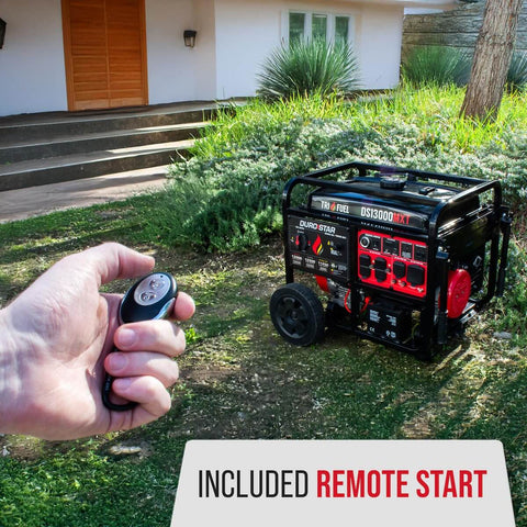 13,000-Watt Tri Fuel Portable Generator With Remote Electric Start shown in a yard, remote control in hand near house steps