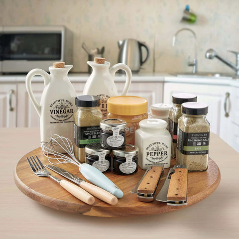 14 inch acacia wood lazy susan cabinet organizer with spices and condiments on kitchen countertop.