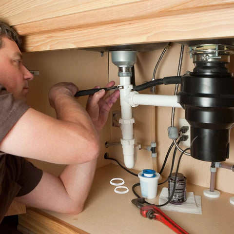 Plumber installing 20 Pack Rubber Cone Seal Rings For One And A Half Inch Waste Pipe And Slip Joint Washers under kitchen sink