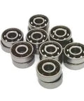 Close-up of 16 inline/Rollerblade/Skate Bearing Chrome Steel Open Ball bearing - Nylon Cage arranged in a pile.
