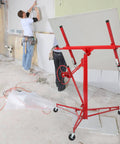 Red 16 FT Drywall Lift Panel Rolling Hoist Jack Lifter Sheetrock in construction setting with workers