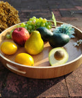 16 Inch Lazy Susan Turntable With Handles Wooden Rotating Tray with fruit, showcasing rustic farmhouse design and raised rim
