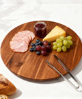 18 Inch Acacia Wood Turntable Organizer Lazy Susan with snacks and tongs on a kitchen table