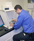 Technician using 18 Inch Portable Vertical Laminar Flow Hood Positive Pressure For ISO Class 5 Cleanroom Lab Use Delivers Filtered Air