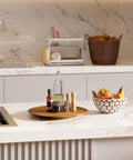 18 Inch Acacia Wood Lazy Susan For Tabletop And Countertop Use with spices on a modern kitchen counter