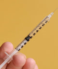 1 mL Syringes With 31G Needle Five Sixteenth Inch Length Individually Wrapped Pack Of 100 For Lab Use, close-up view in hand