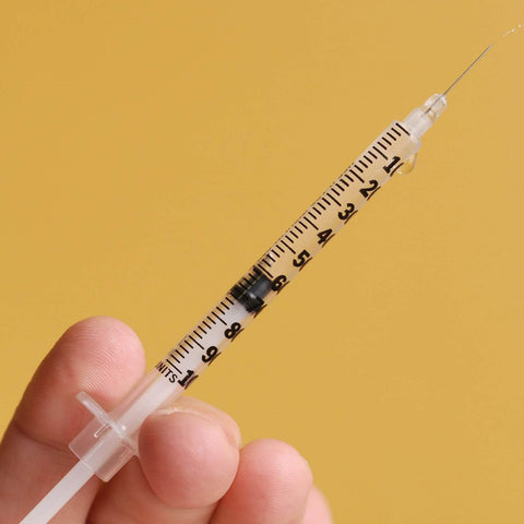 1 mL Syringes With 31G Needle Five Sixteenth Inch Length Individually Wrapped Pack Of 100 For Lab Use, close-up view in hand