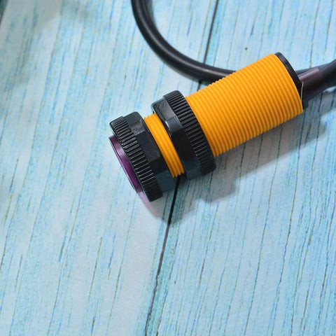 Close-up of yellow 2 Pack Infrared Photoelectric Sensor Module E18 D80NK for obstacle detection in robotics projects