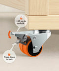 Close-up of a heavy duty double wheeled orange TPE casters with brake from the 2 inch caster wheels set of 64, showcasing locking mechanism.