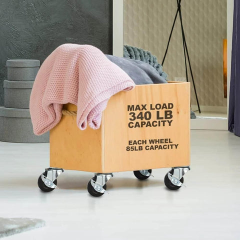 48 Pack 2 Inch Swivel Caster Wheels with Side Brake on wooden cart holding blankets, showcasing 85 lb each wheel capacity.