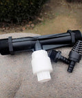 2 Inch Venturi Fertilizer Injector for irrigation systems, showing black and white components on a stone surface for garden use