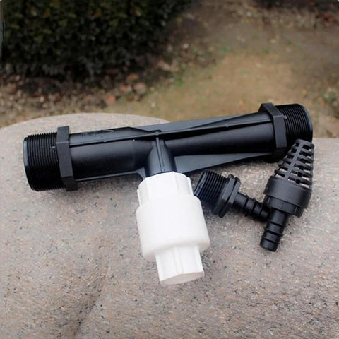 2 Inch Venturi Fertilizer Injector for irrigation systems, showing black and white components on a stone surface for garden use