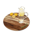 20 inch acacia wood lazy susan turntable designed for tables and counters, featuring a pitcher and lemons on top.