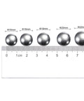20mm carbon steel bearing balls next to a ruler, showcasing precision polished surface. Part of 10pcs 20mm Carbon Steel Bearing Balls Precision Polished.