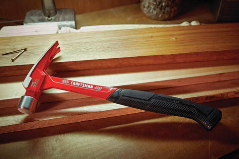 20 oz steel general purpose hammer with an ergonomic vibration-reducing grip, smooth face, and one-piece forged design on a workbench