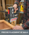 Person using 20V cordless 2-in-1 brad nailer and stapler for trim, cabinetry, and light framing in a workshop setting