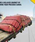 Flatbed truck secured with 50 Pack 21 Inch Natural Rubber Tarp Bungee Straps With S Hooks Tie Downs For Heavy Duty Tarps Securing Equipment And Gear Natural Rubber Construction From Sri Lanka With Galvanized Steel S Hooks Crimped On End To Protect Tarps.