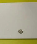 Virgin PTFE Sheet Quarter Inch Thick 12 By 12 Inches Nonstick High Purity Polytetrafluoroethylene on a yellow background with a coin for scale.