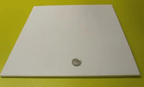 Virgin PTFE Sheet Quarter Inch Thick 12 By 12 Inches Nonstick High Purity Polytetrafluoroethylene on a yellow background with a coin for scale.
