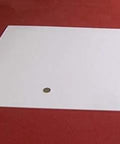 Virgin PTFE Sheet One Eighth Inch Thick By Twenty Four Inch By Twenty Four Inch Industrial Grade High Purity on red background.