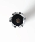 Top-down view: carbide-tipped annular cutter with Weldon shank, silver toothed rim surrounding black center.