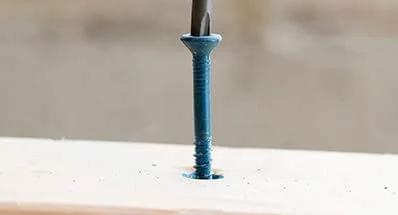 One Quarter Inch By Three And One Quarter Inch Tapcon Hex Washer Head Concrete Screw For Anchoring To Masonry Brick Or Block installed in concrete