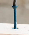 Rock Solid Quarter Inch By One And A Quarter Inch Hex Head Concrete Screw For Masonry Anchoring With Climaseal Coating No Hole Spotting Fast Install Three Anchors Per Minute 500 Pack shown installed in wood